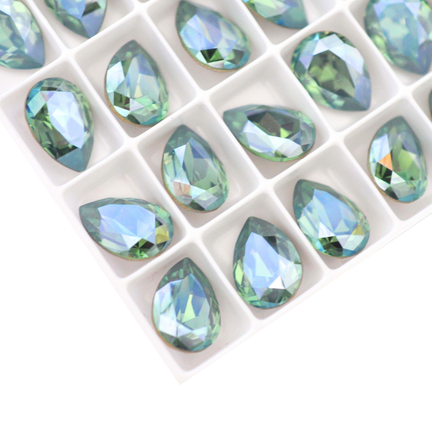 Pear shape faceted Austrian crystal rhinestones in the color Erinite Moonlight displayed on a white background.