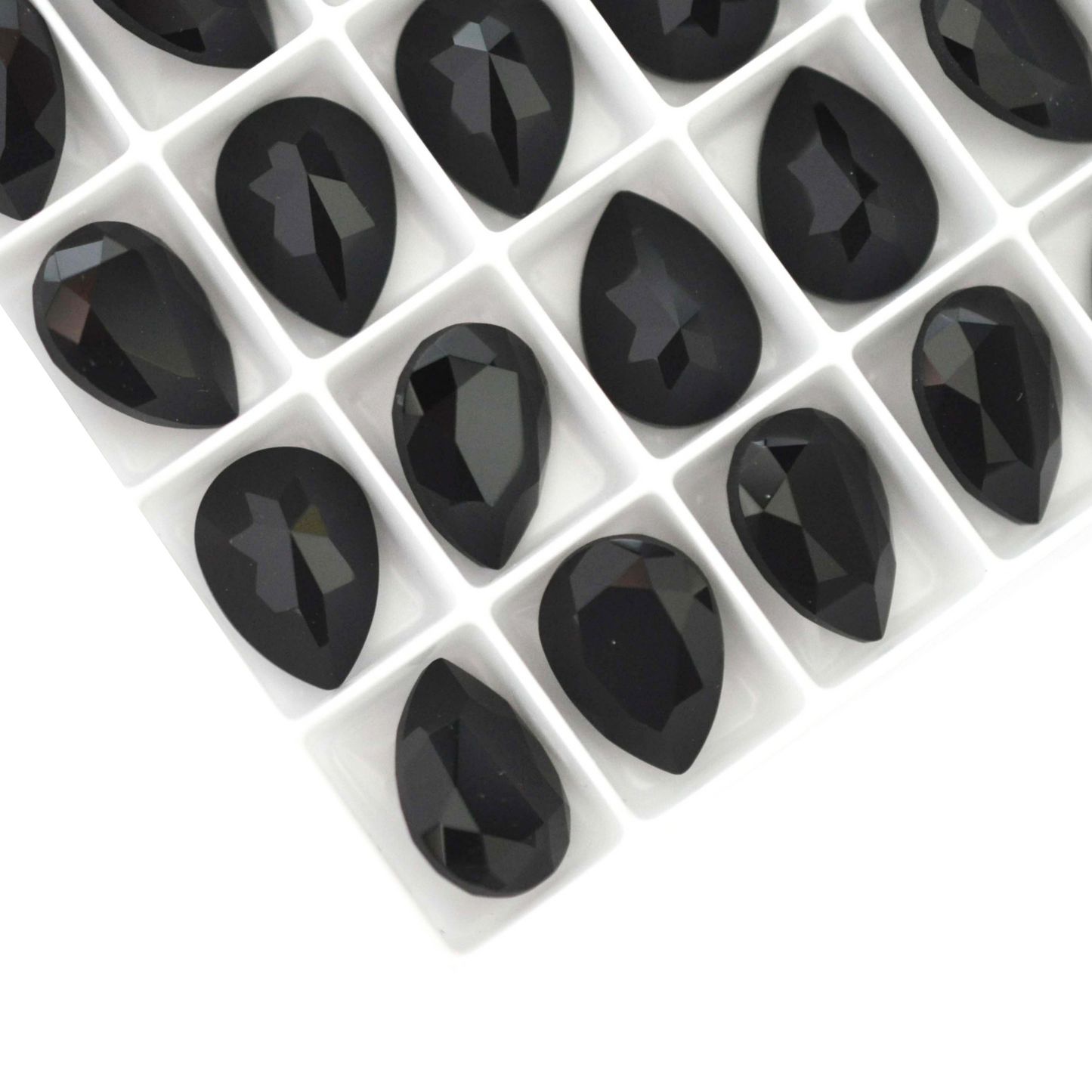 Pear shape faceted Austrian crystal rhinestones in the color Jet displayed on a white background.