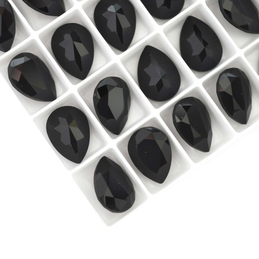Pear shape faceted Austrian crystal rhinestones in the color Jet displayed on a white background.
