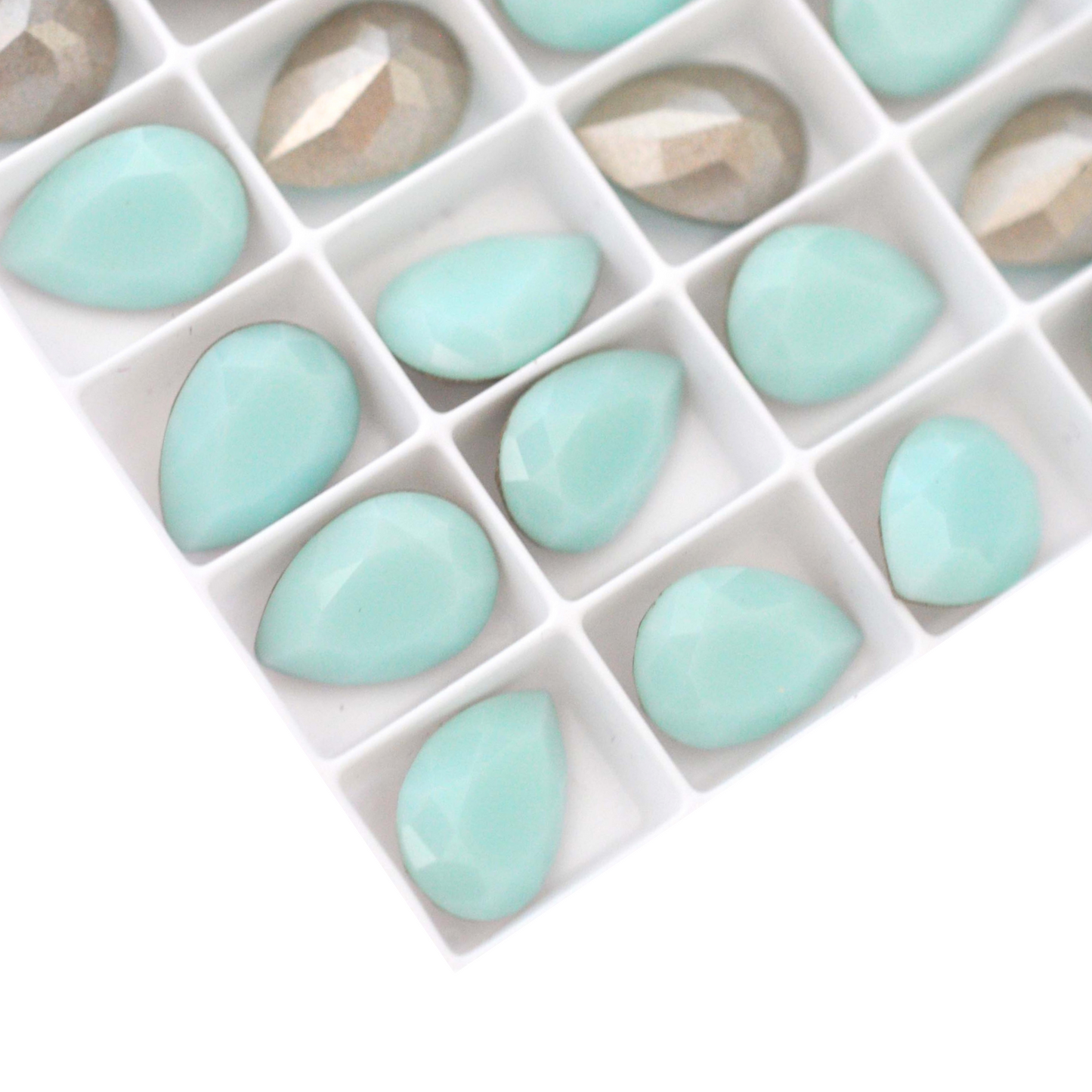 Pear shape faceted Austrian crystal rhinestones in the color Mint Green displayed on a white background.