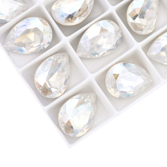 Pear shape faceted Austrian crystal rhinestones in the color Moonlight displayed on a white background.