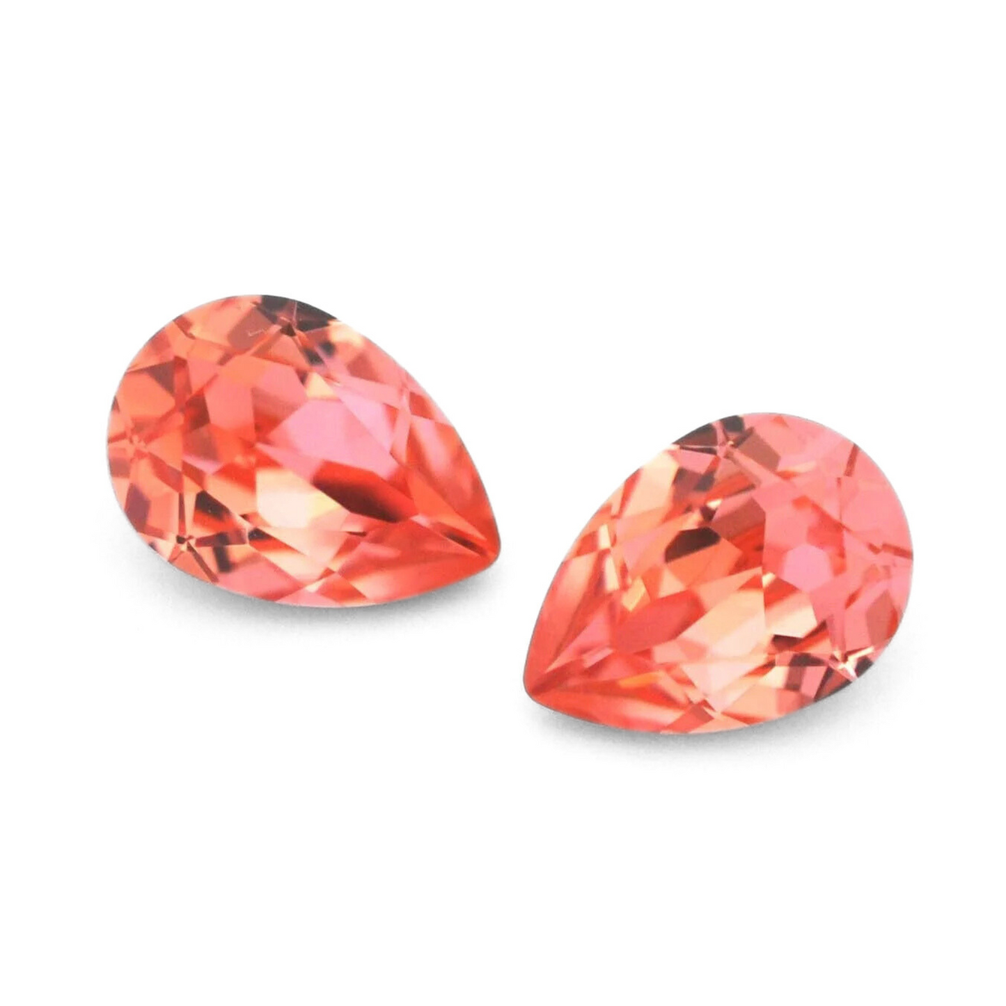 Pear shape faceted Austrian crystal rhinestones in the color Rose Peach displayed on a white background.
