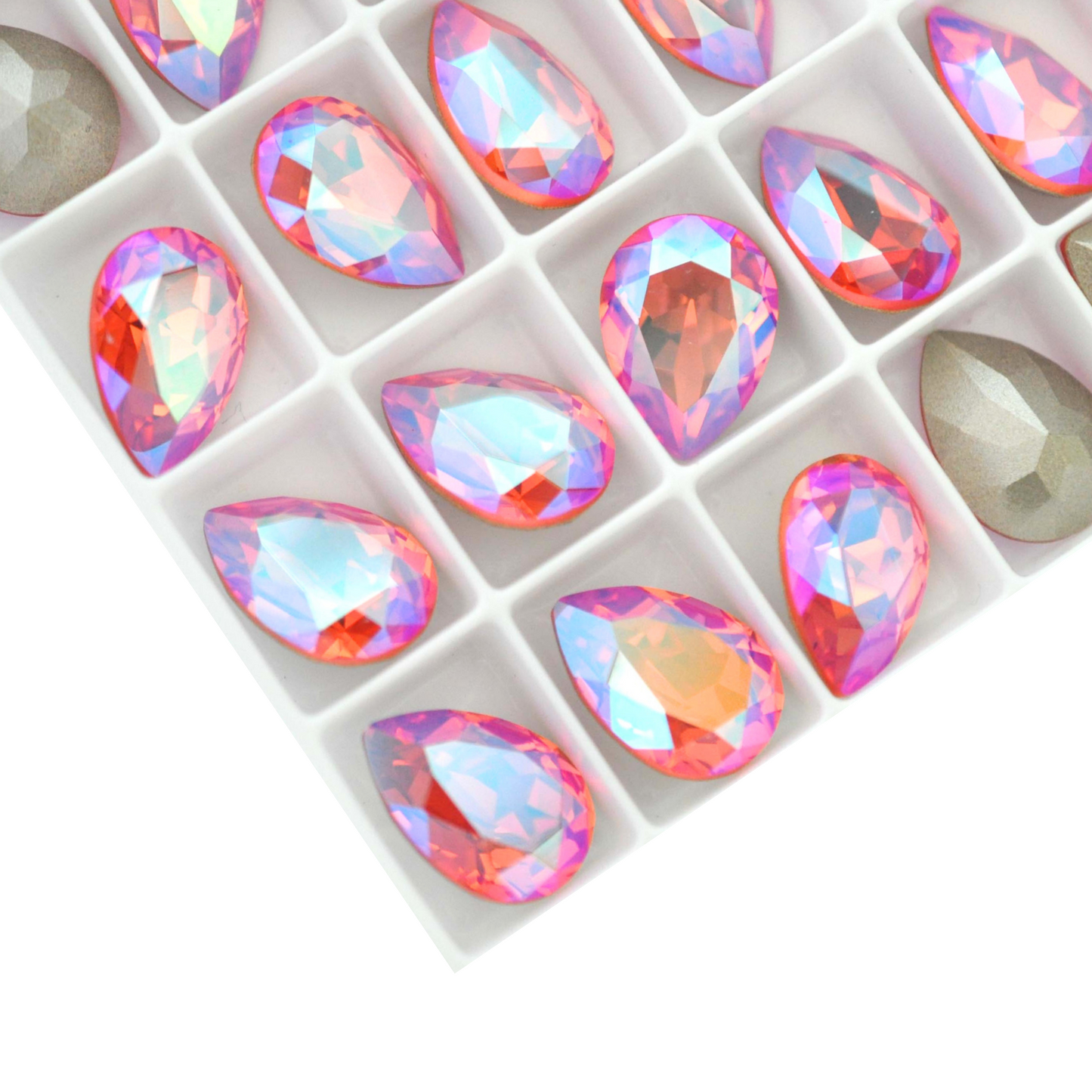 Pear shape faceted Austrian crystal rhinestones in the color Rose Peach Shimmer displayed on a white background.