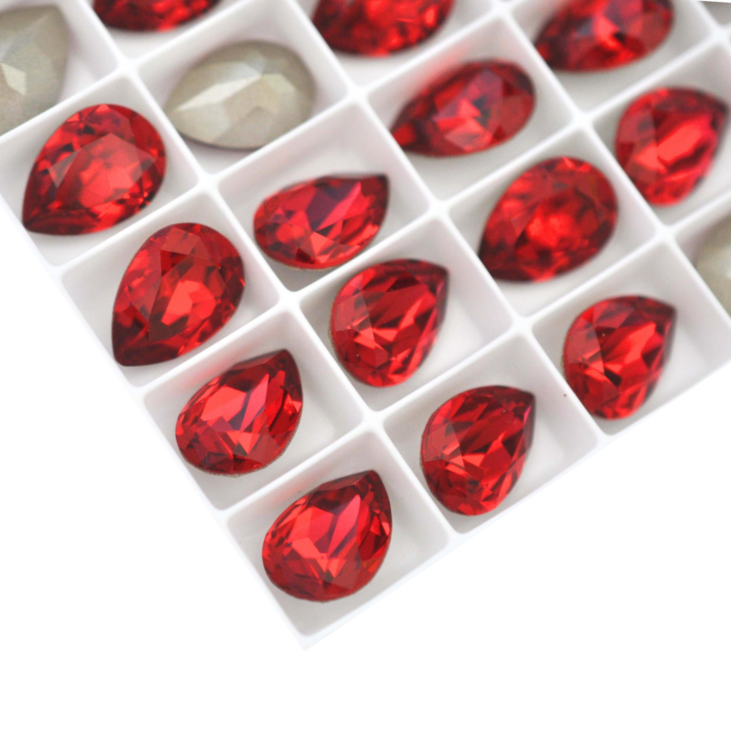 Pear shape faceted Austrian crystal rhinestones in the color Scarlet displayed on a white background.