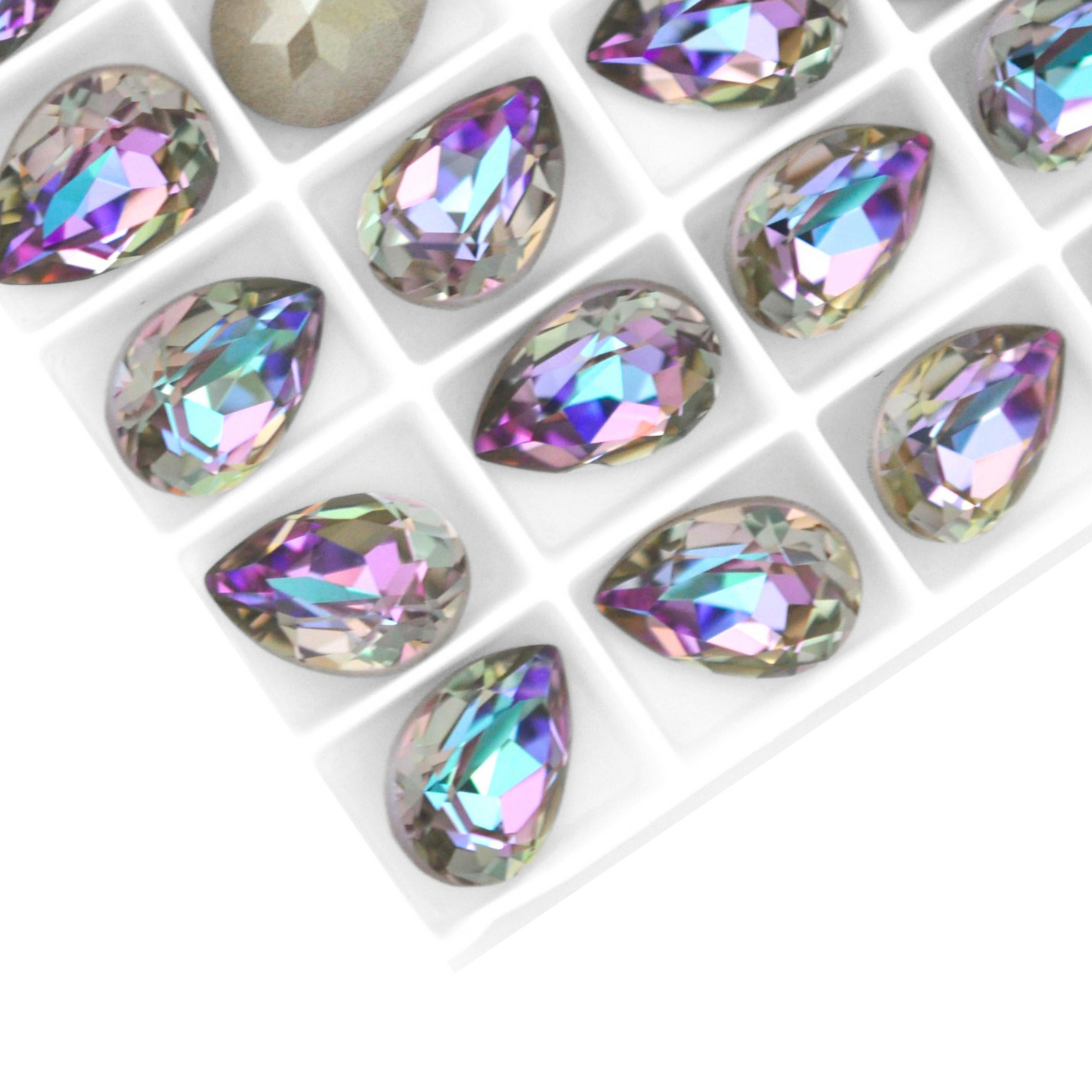 Pear shape faceted Austrian crystal rhinestones in the color Vitrail Light displayed on a white background.