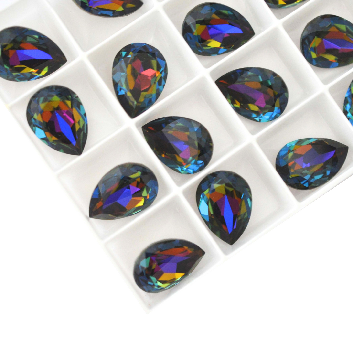 Pear shape faceted Austrian crystal rhinestones in the color Blue Volcano displayed on a white background.