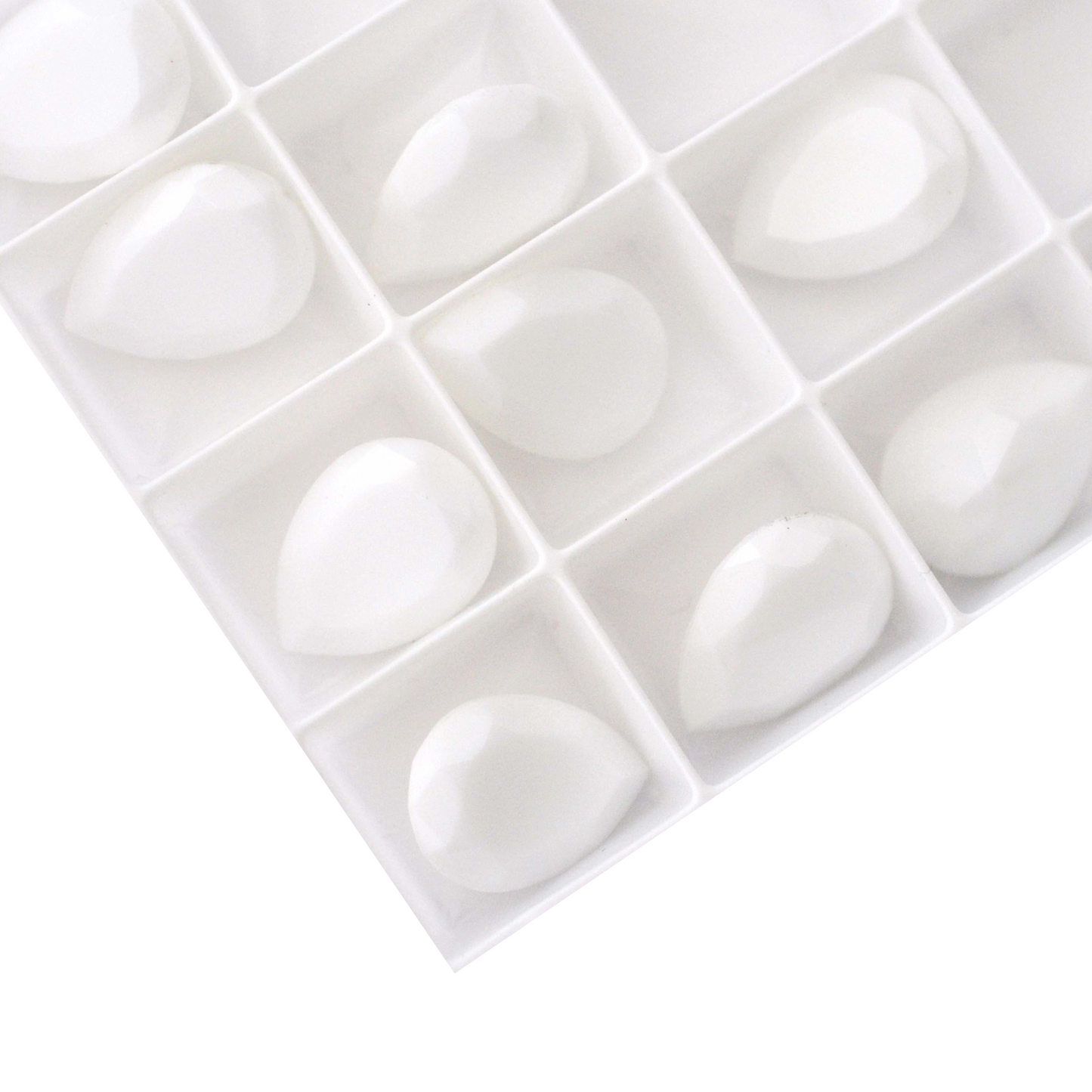 Pear shape faceted Austrian crystal rhinestones in the color Chalk White displayed on a white background.