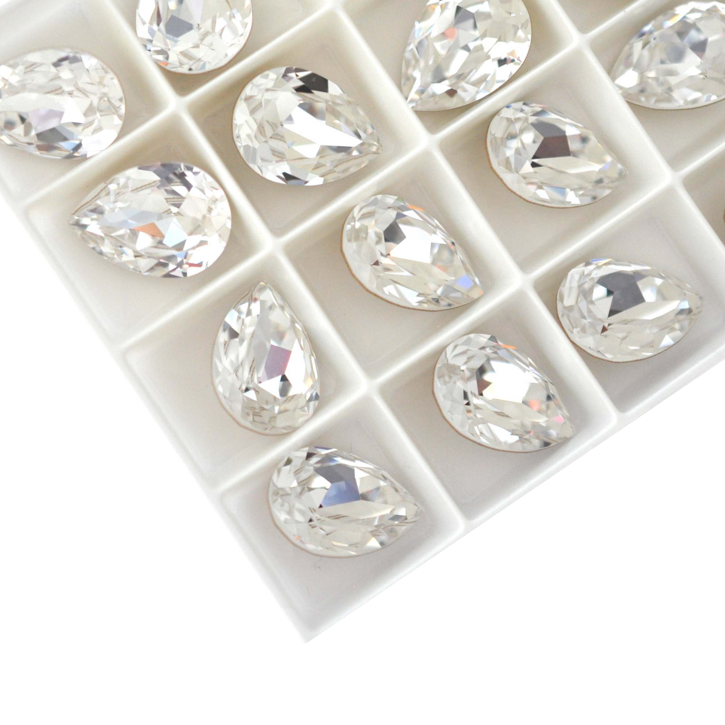 Pear shape faceted Austrian crystal rhinestones in the color Crystal displayed on a white background.