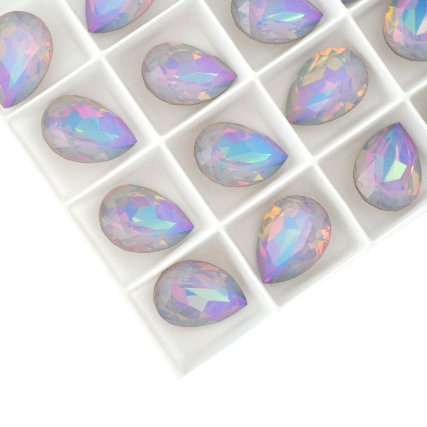 Pear shape faceted Austrian crystal rhinestones in the color Dreamy Vitrail displayed on a white background.