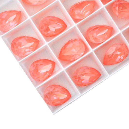 Pear shape faceted Austrian crystal rhinestones in the color Flamingo Ignite displayed on a white background.