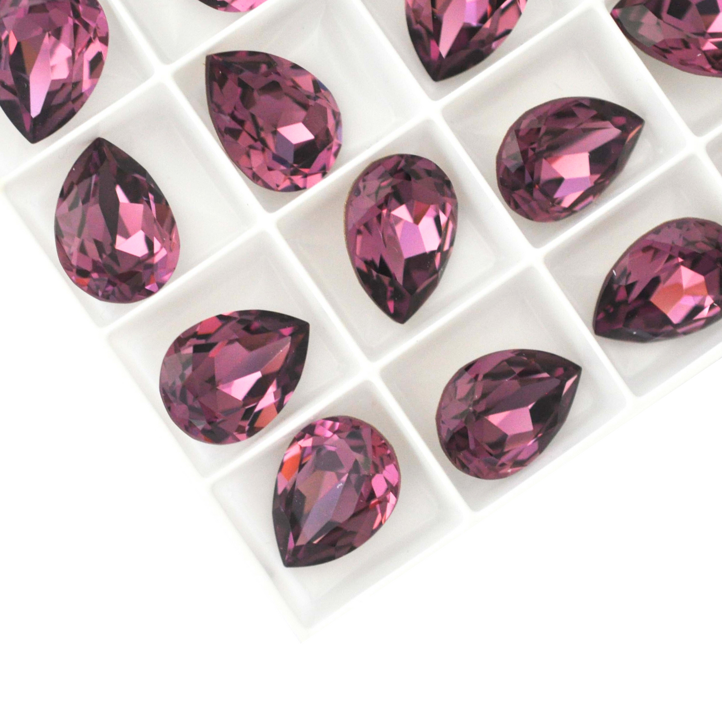 Pear shape faceted Austrian crystal rhinestones in the color Iris displayed on a white background.