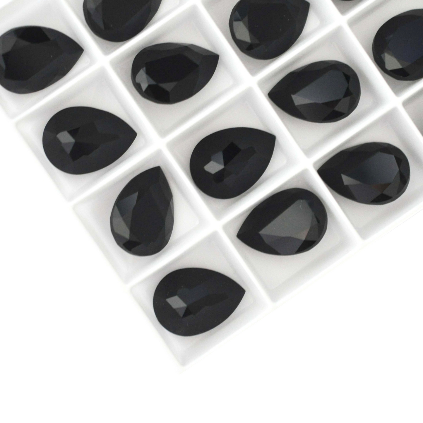 Pear shape faceted Austrian crystal rhinestones in the color Jet Black displayed on a white background.