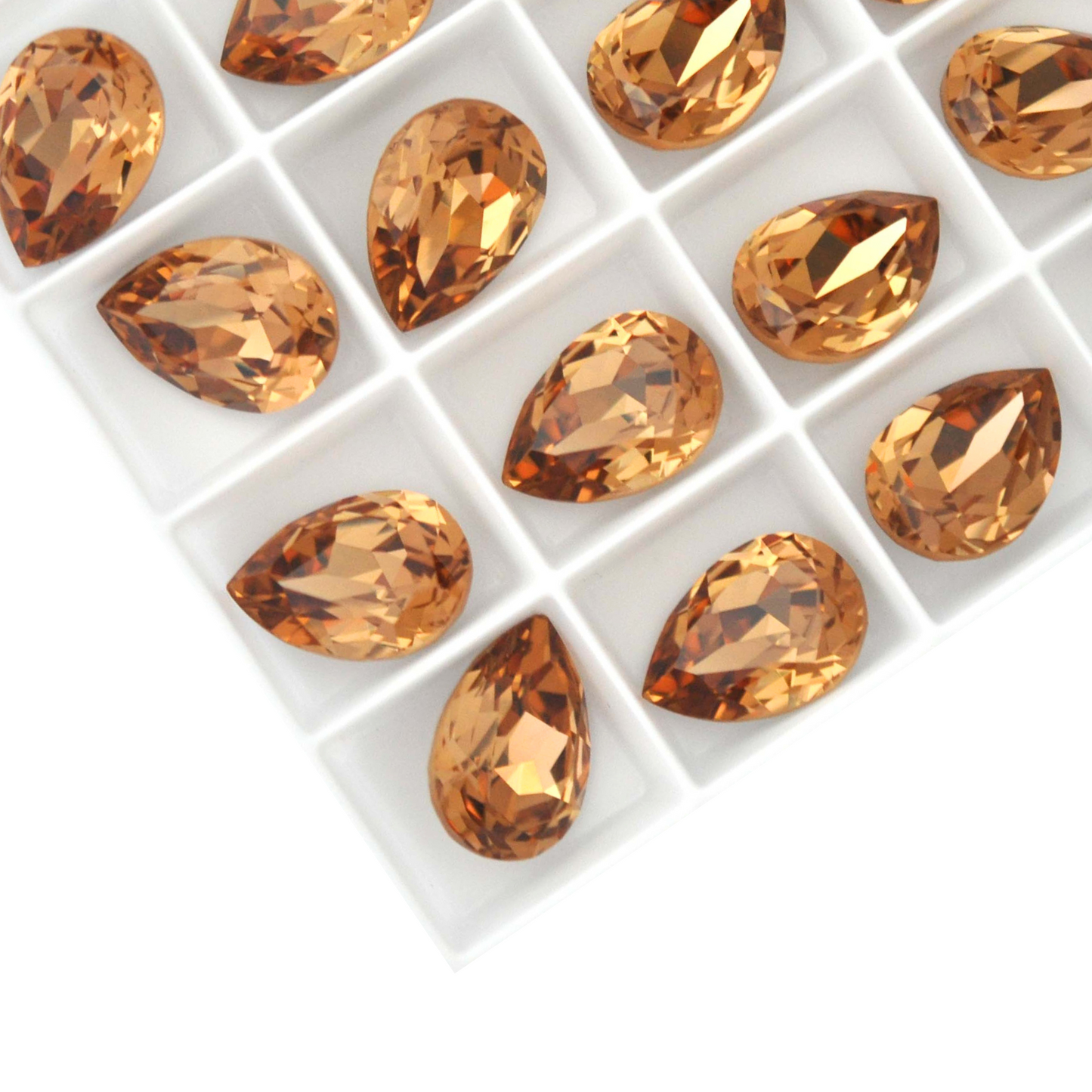 Pear shape faceted Austrian crystal rhinestones in the color Light Colorado Topaz displayed on a white background.