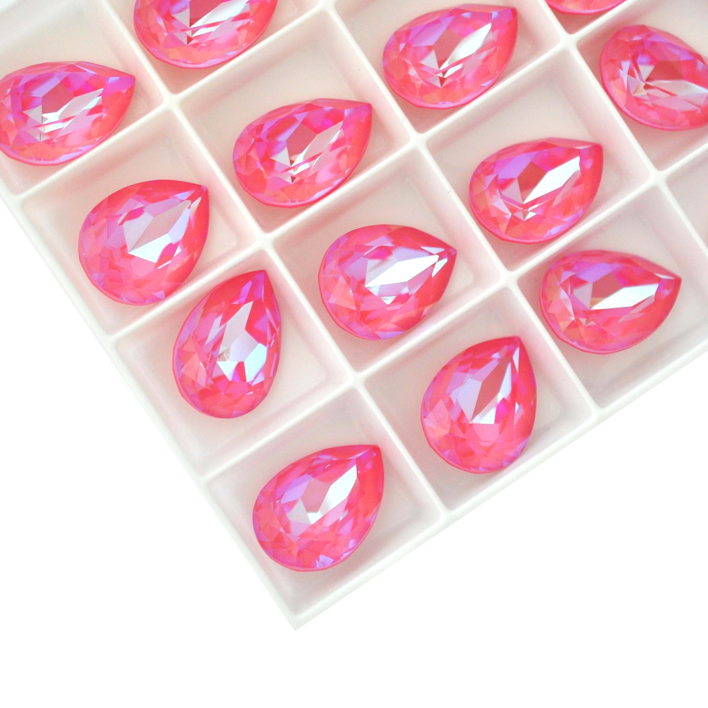 Pear shape faceted Austrian crystal rhinestones in the color Lotus Pink Delite displayed on a white background.