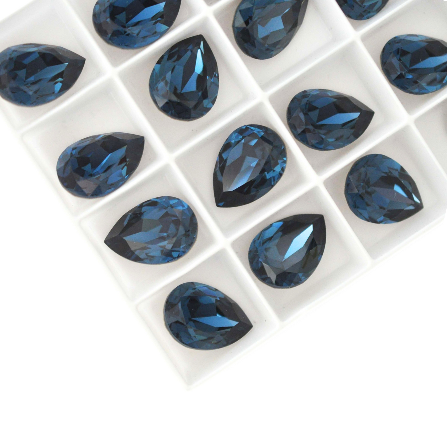 Pear shape faceted Austrian crystal rhinestones in the color Montana displayed on a white background.