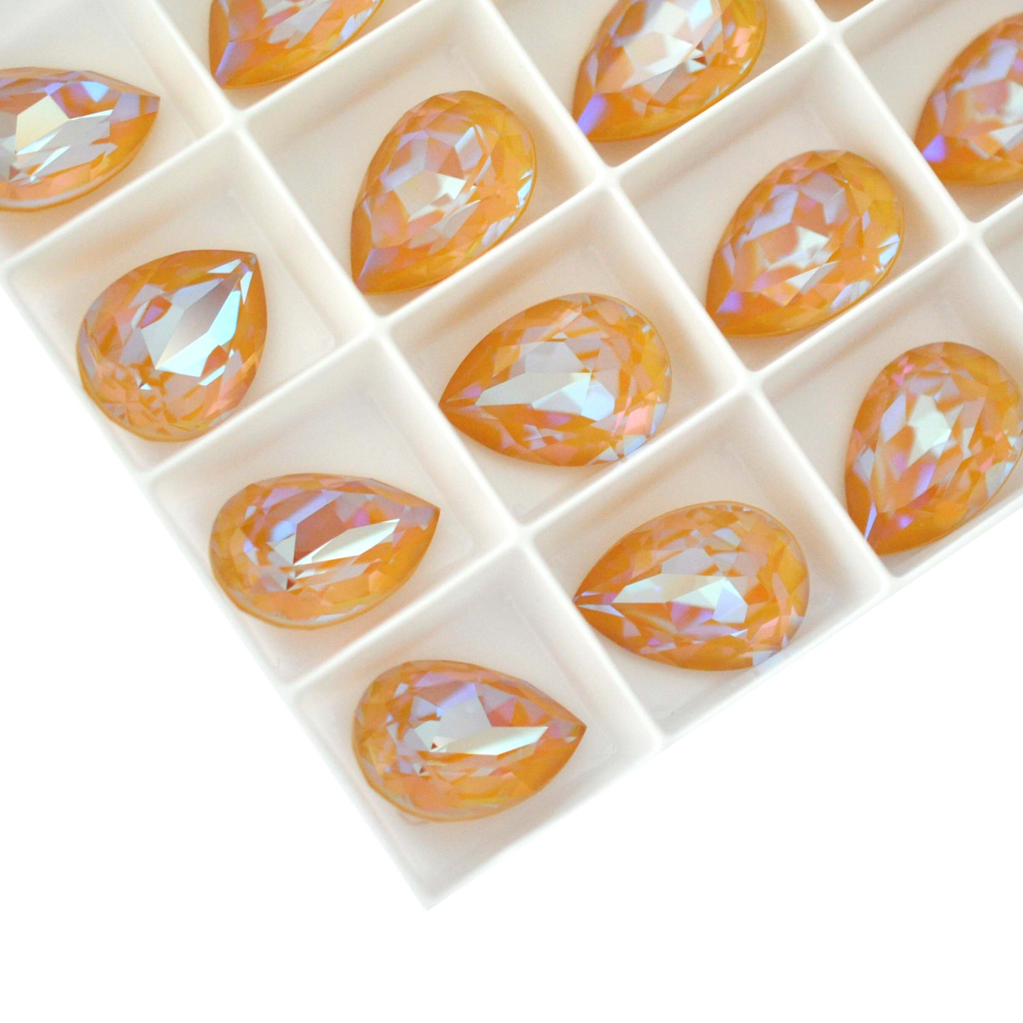 Pear shape faceted Austrian crystal rhinestones in the color Ochre Delite displayed on a white background.
