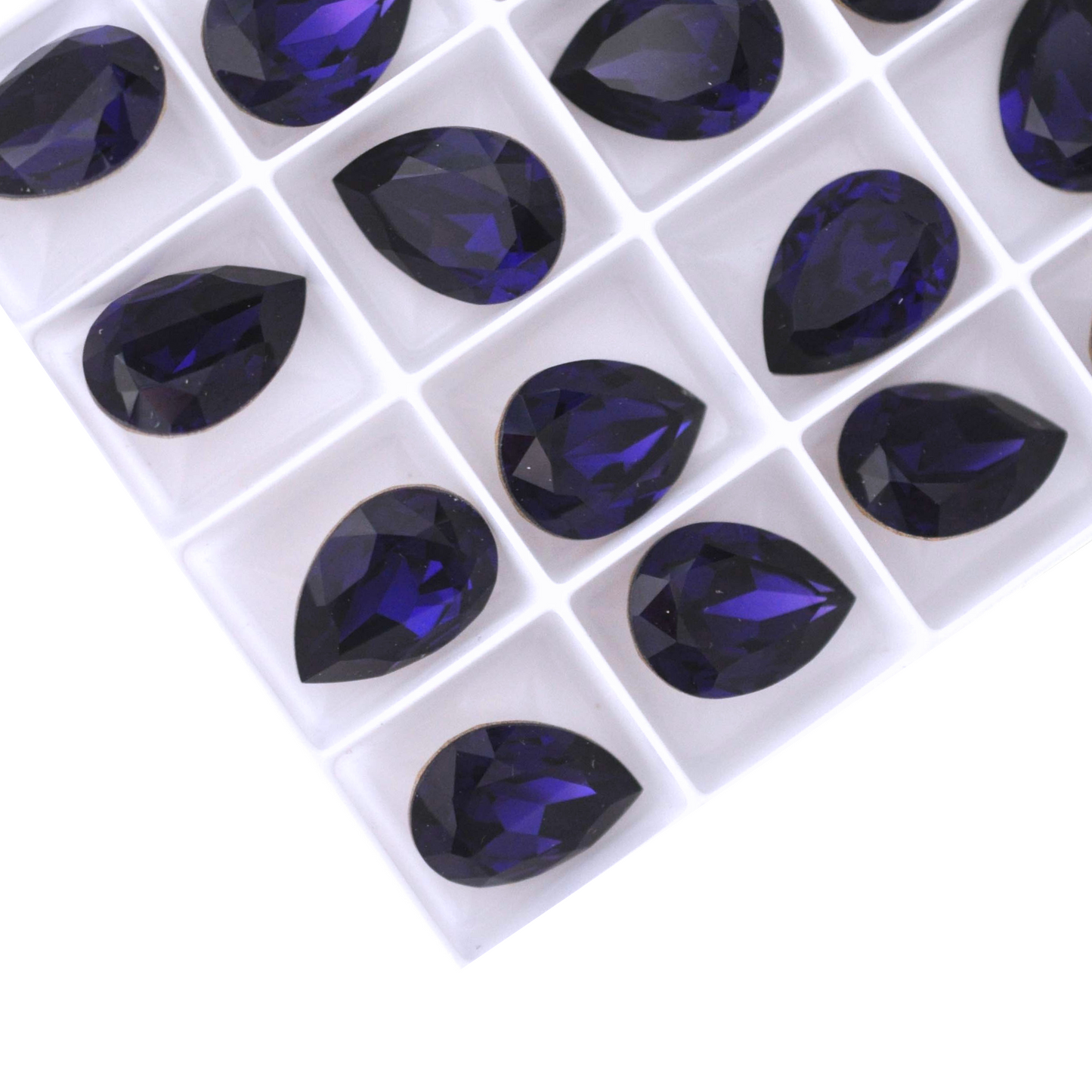 Pear shape faceted Austrian crystal rhinestones in the color Purple Velvet displayed on a white background.