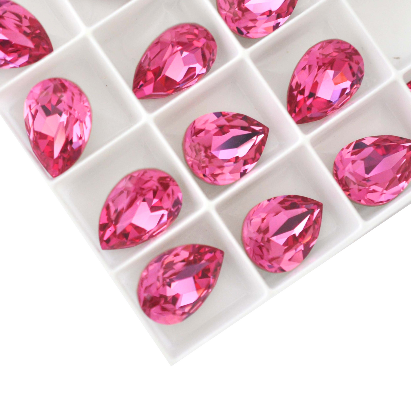 Pear shape faceted Austrian crystal rhinestones in the color Rose displayed on a white background.