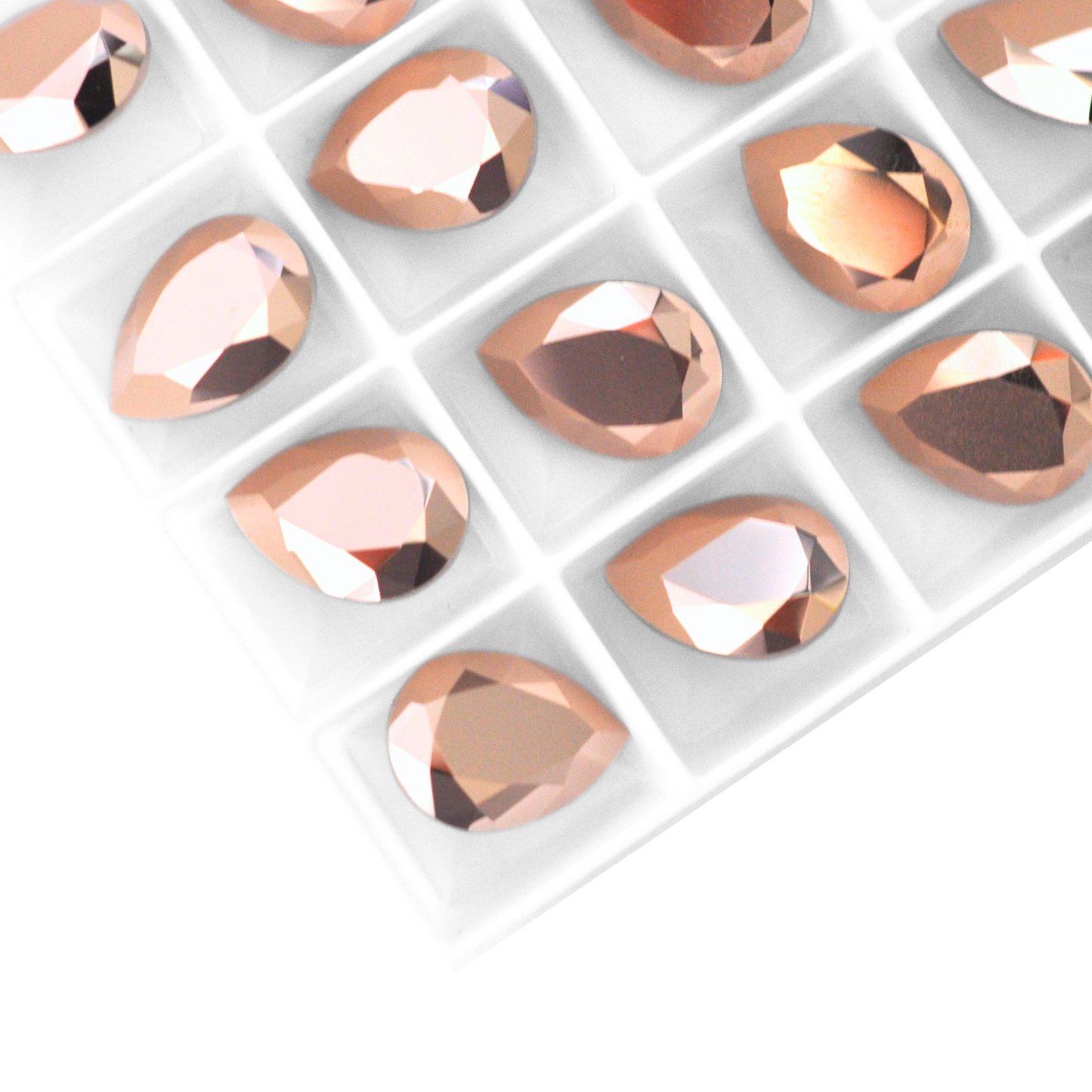 Pear shape faceted Austrian crystal rhinestones in the color Rose Gold displayed on a white background.