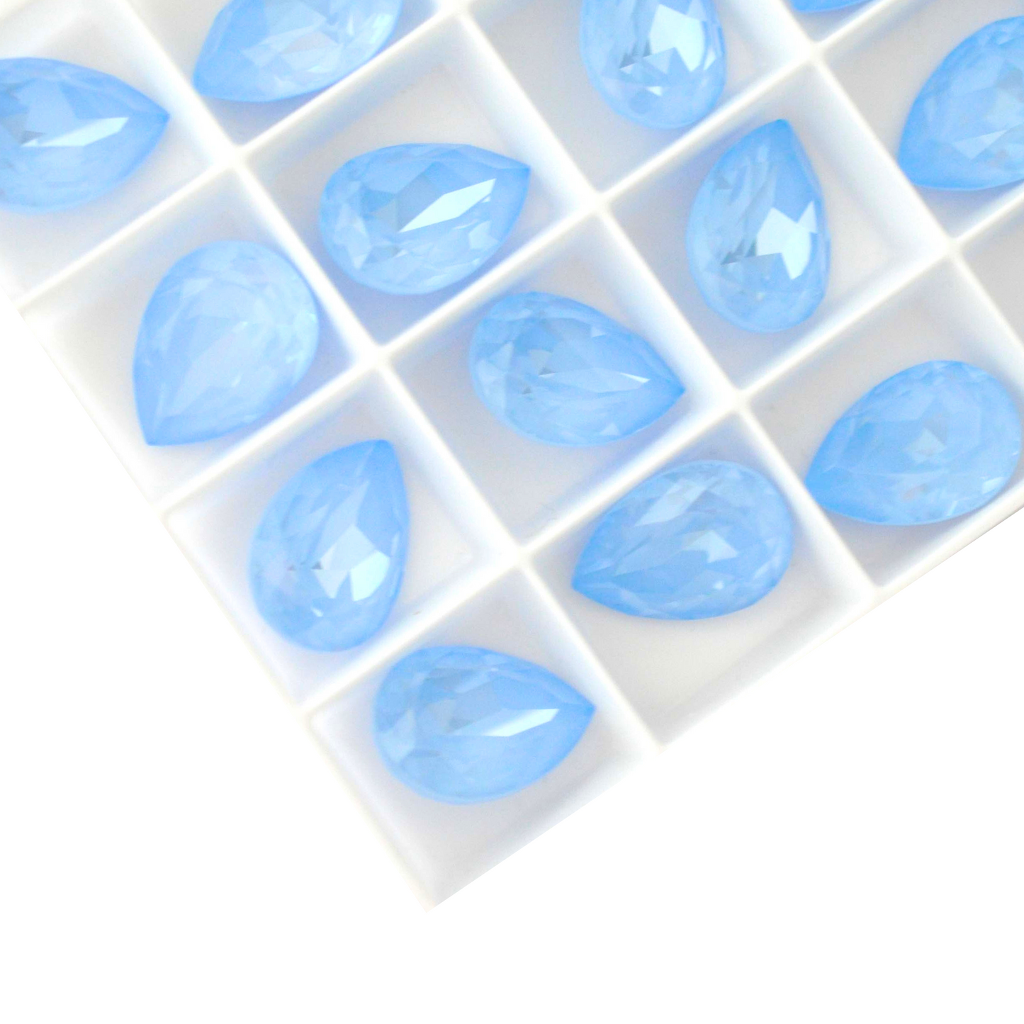 Pear shape faceted Austrian crystal rhinestones in the color Sky Ignite displayed on a white background.