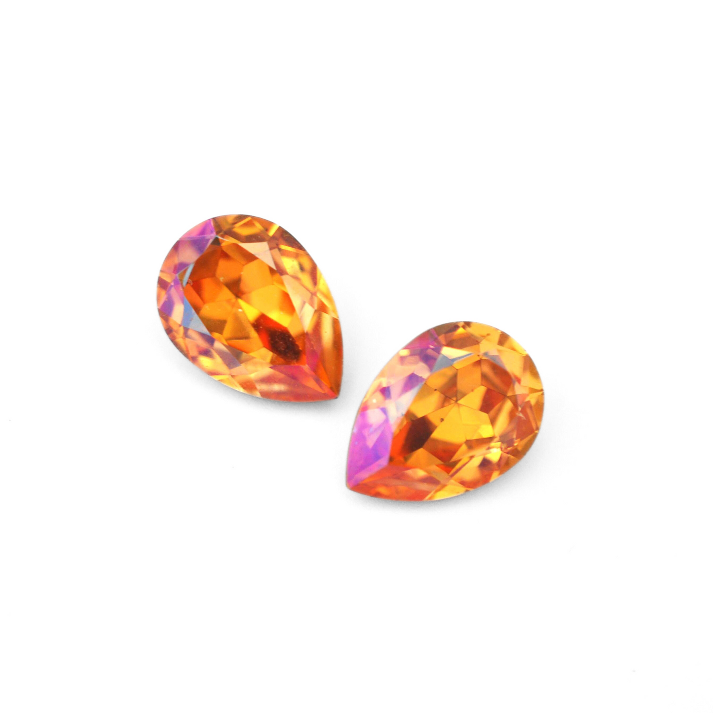 Pear shape faceted Austrian crystal rhinestones in the color Summer Blush displayed on a white background.