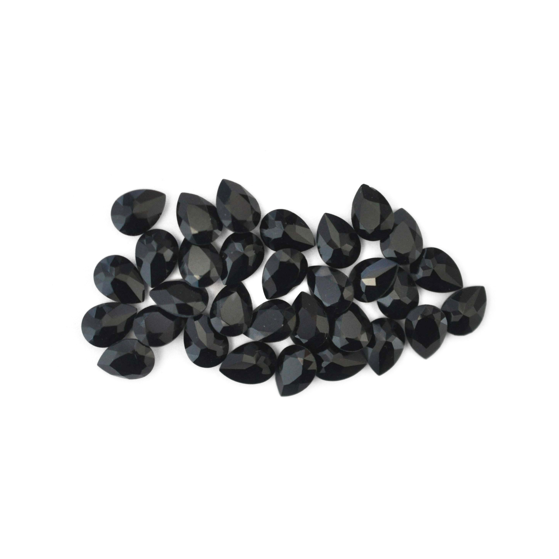 Pear shaped faceted Austrian crystal rhinestones in the colorJet displayed on a white background.