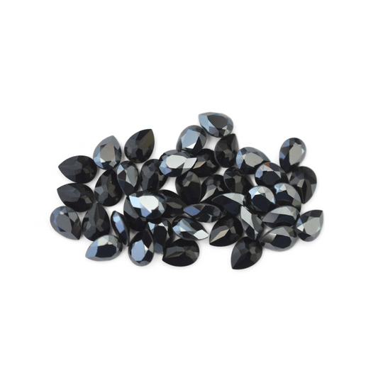 Pear shaped faceted Austrian crystal rhinestones in the color Jet Hematite displayed on a white background.