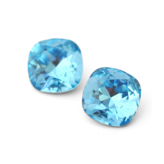 Cushion Square faceted Austrian crystal rhinestones in the color Aquamarine displayed on a white background.