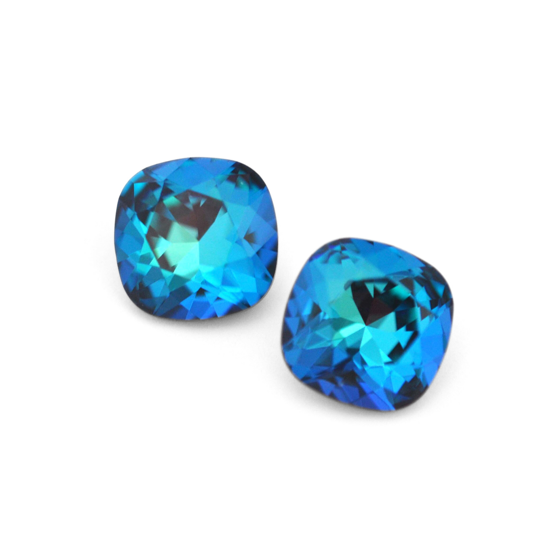 Cushion Square faceted Austrian crystal rhinestones in the color Bermuda Blue displayed on a white background.