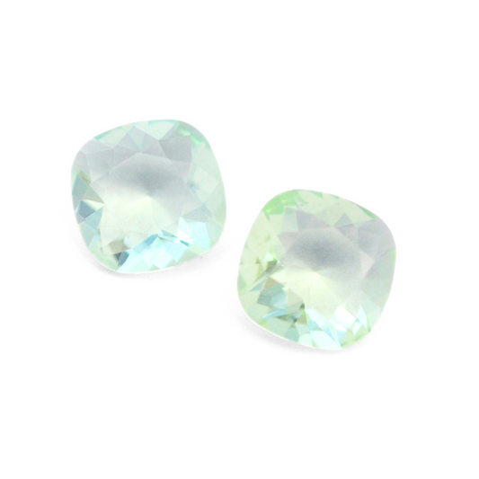 Cushion Square faceted Austrian crystal rhinestones in the color Chrysolite Unfoiled displayed on a white background.