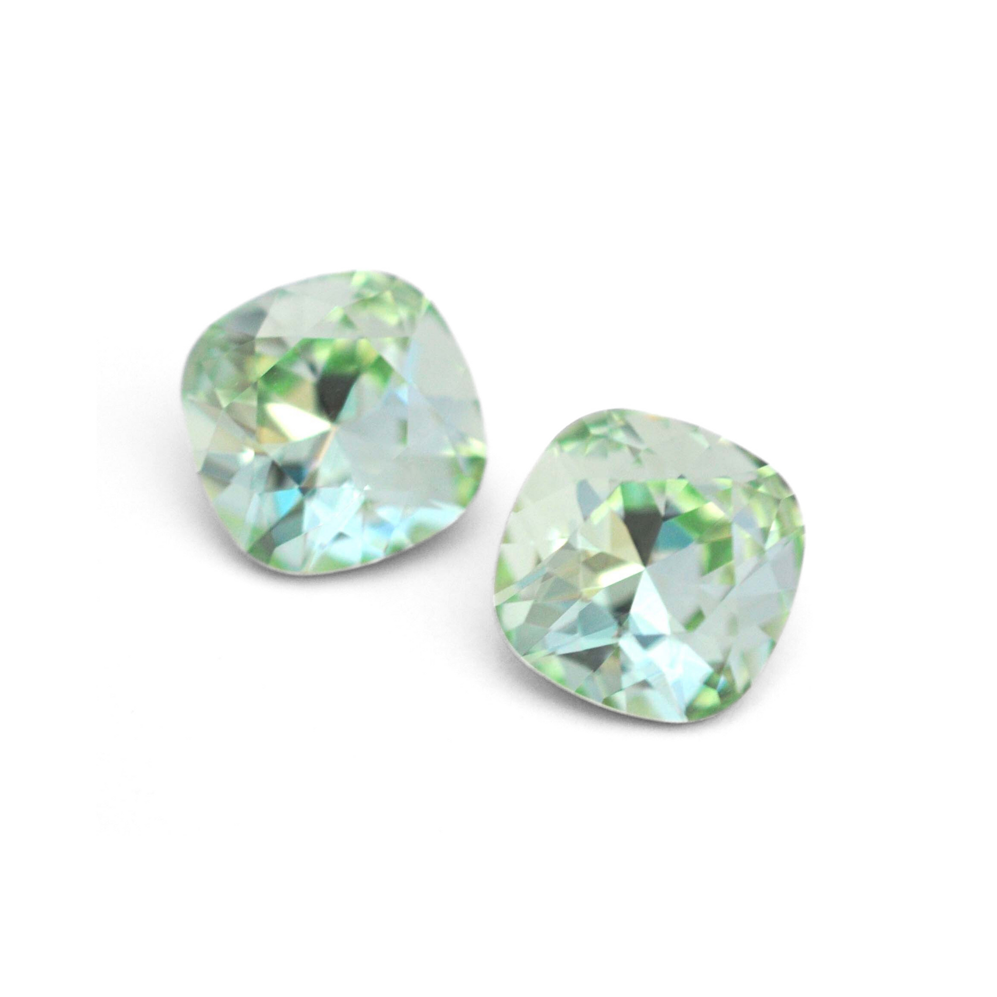 Cushion Square faceted Austrian crystal rhinestones in the color Chrysolite displayed on a white background.