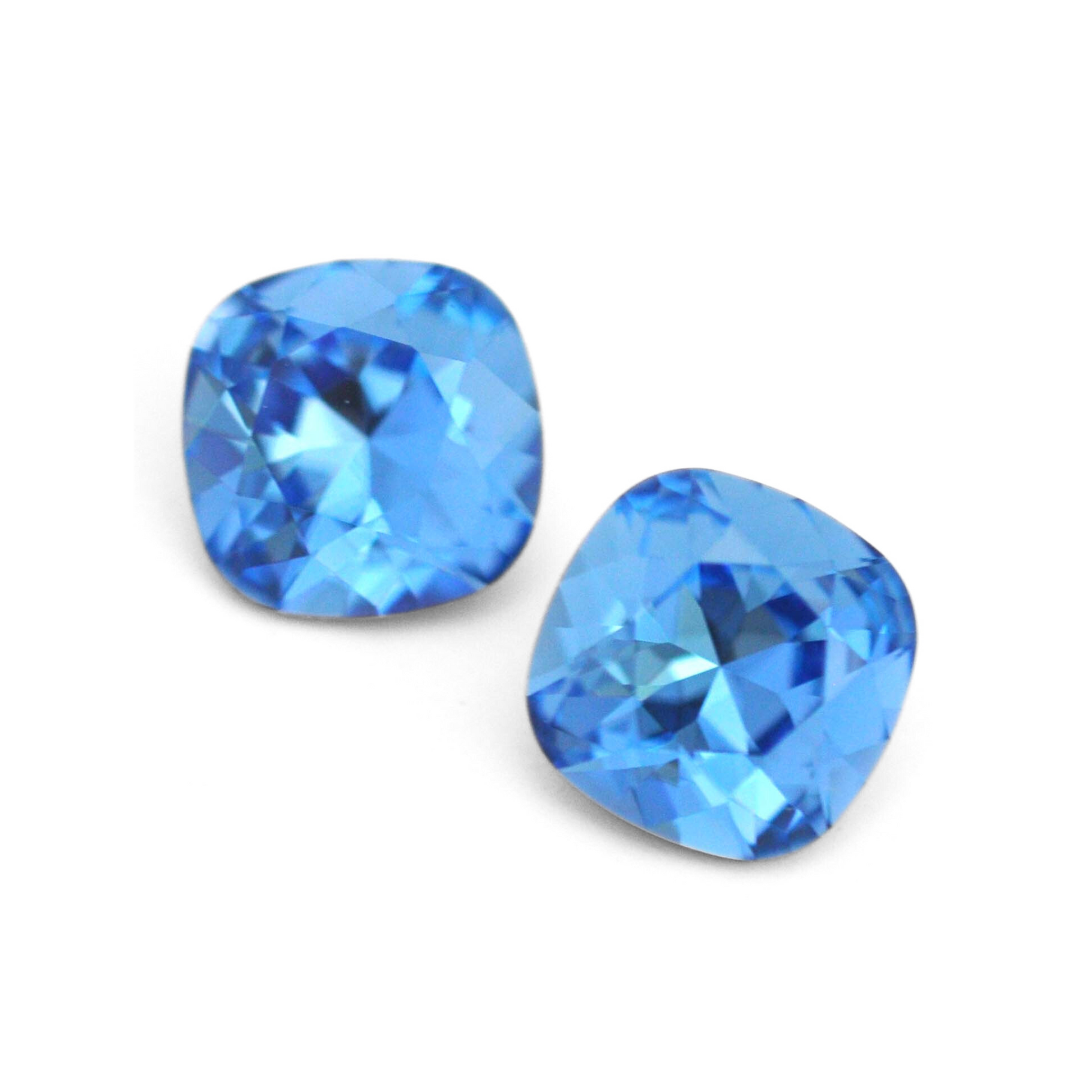 Cushion Square faceted Austrian crystal rhinestones in the color Cool Blue displayed on a white background.