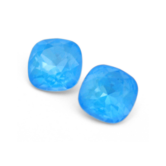 Cushion Square faceted Austrian crystal rhinestones in the color Electric Blue Ignite displayed on a white background.