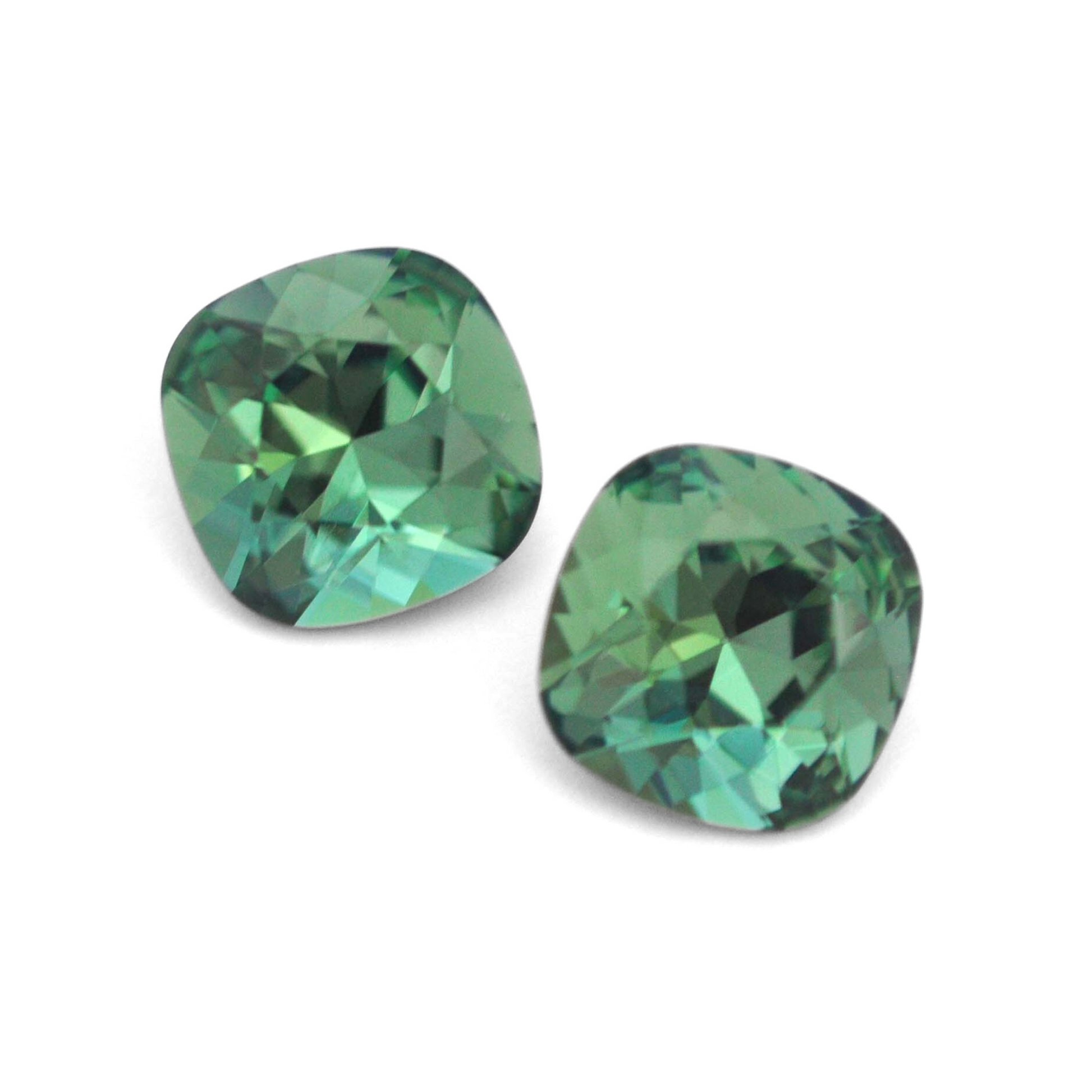 Cushion Square faceted Austrian crystal rhinestones in the color Erinite displayed on a white background.