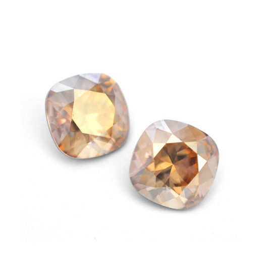 Cushion Square faceted Austrian crystal rhinestones in the color Golden Shadow displayed on a white background.