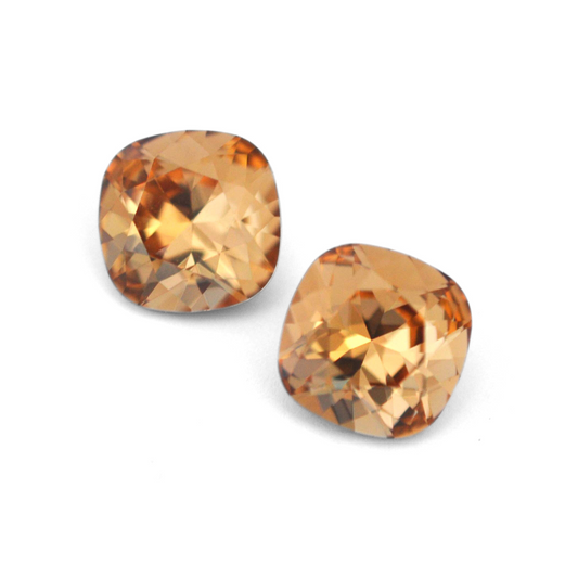 Cushion Square faceted Austrian crystal rhinestones in the color Light Colorado Topaz displayed on a white background.