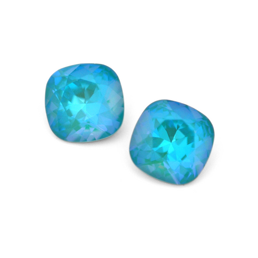 Cushion Square faceted Austrian crystal rhinestones in the color Laguna Delite displayed on a white background.