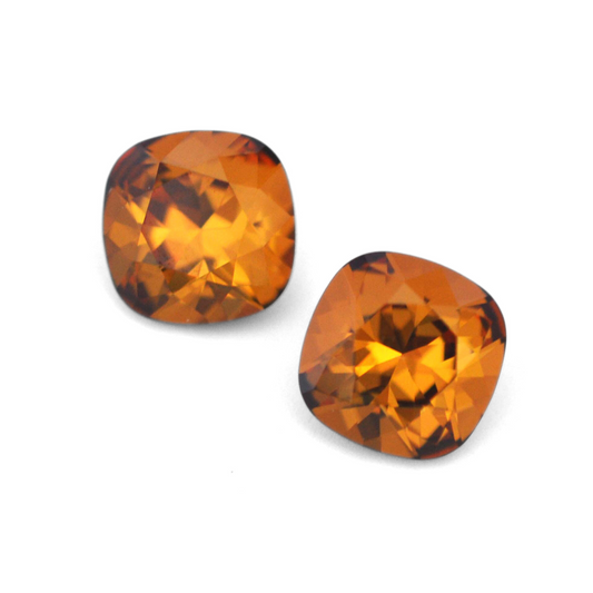Cushion Square faceted Austrian crystal rhinestones in the color Light Amber displayed on a white background.