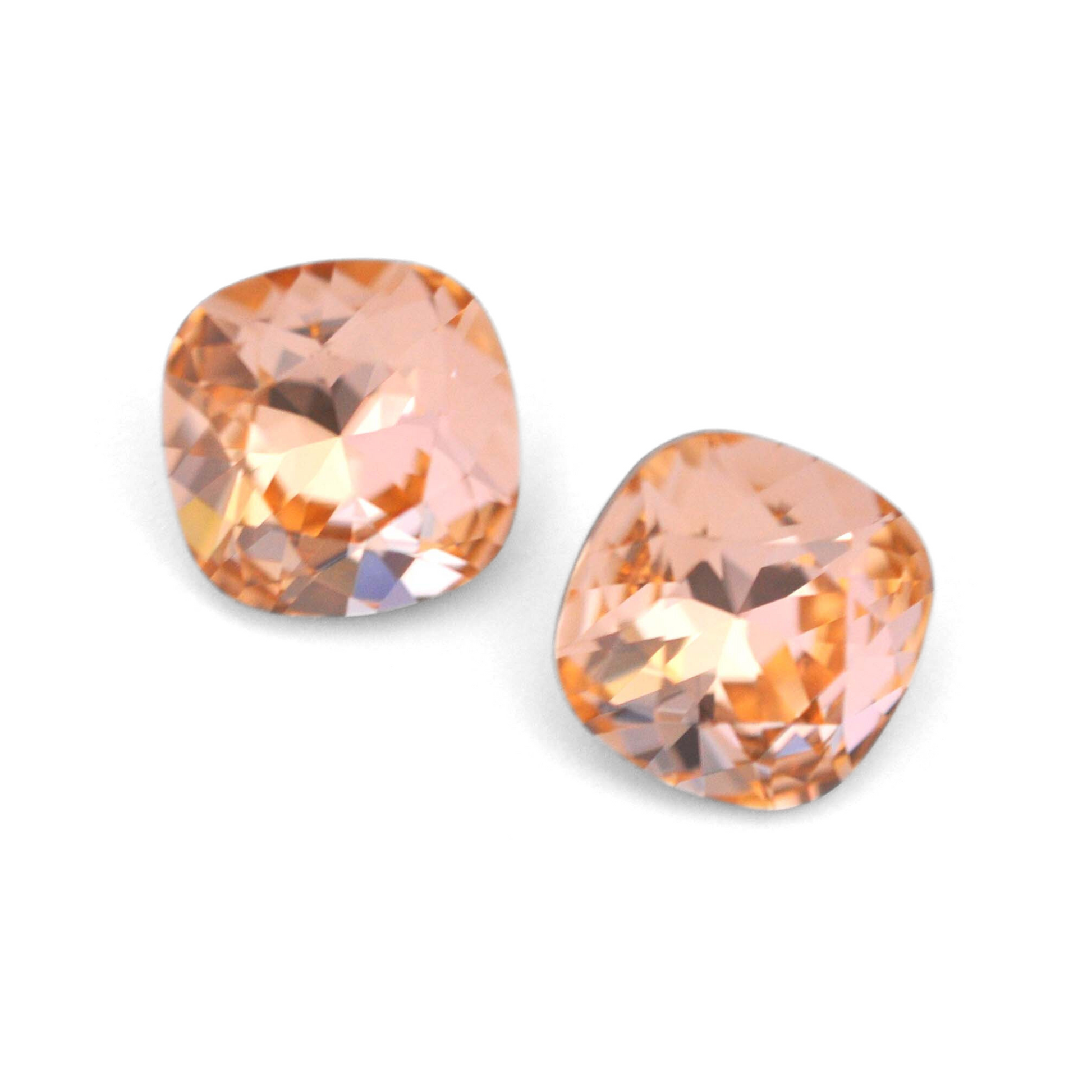 Cushion Square faceted Austrian crystal rhinestones in the color Light Peach displayed on a white background.