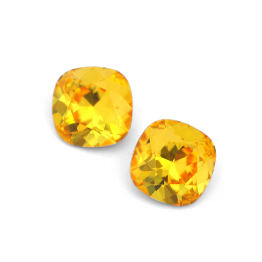 Cushion Square faceted Austrian crystal rhinestones in the color Light Topaz displayed on a white background.