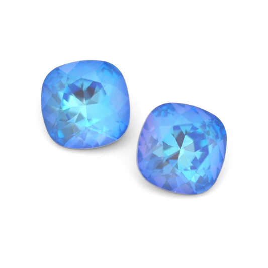 Cushion Square faceted Austrian crystal rhinestones in the color Ocean Delite displayed on a white background.