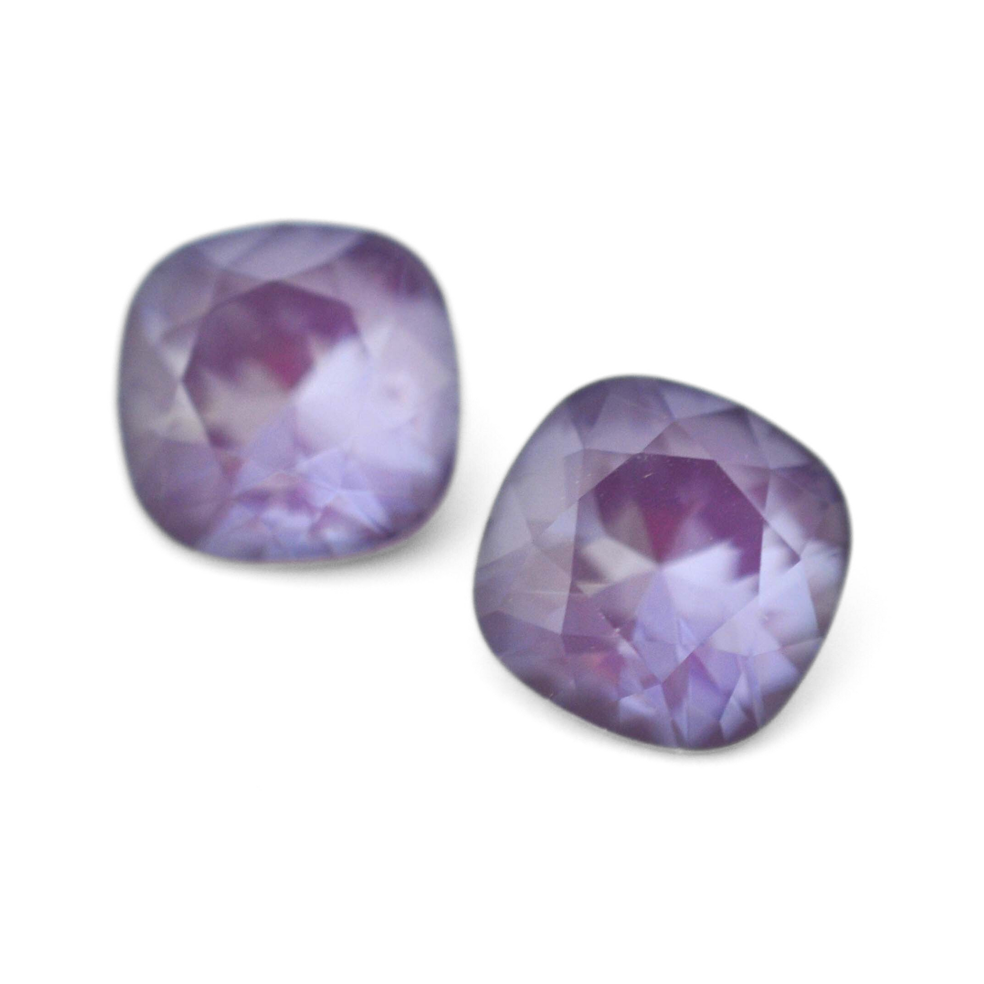 Cushion Square faceted Austrian crystal rhinestones in the color Purple Ignite displayed on a white background.