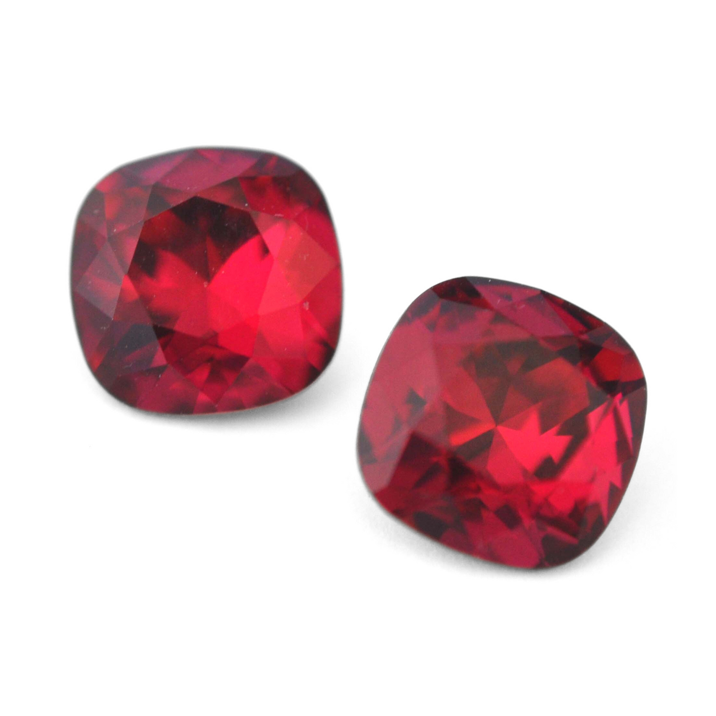 Cushion Square faceted Austrian crystal rhinestones in the color Ruby displayed on a white background.