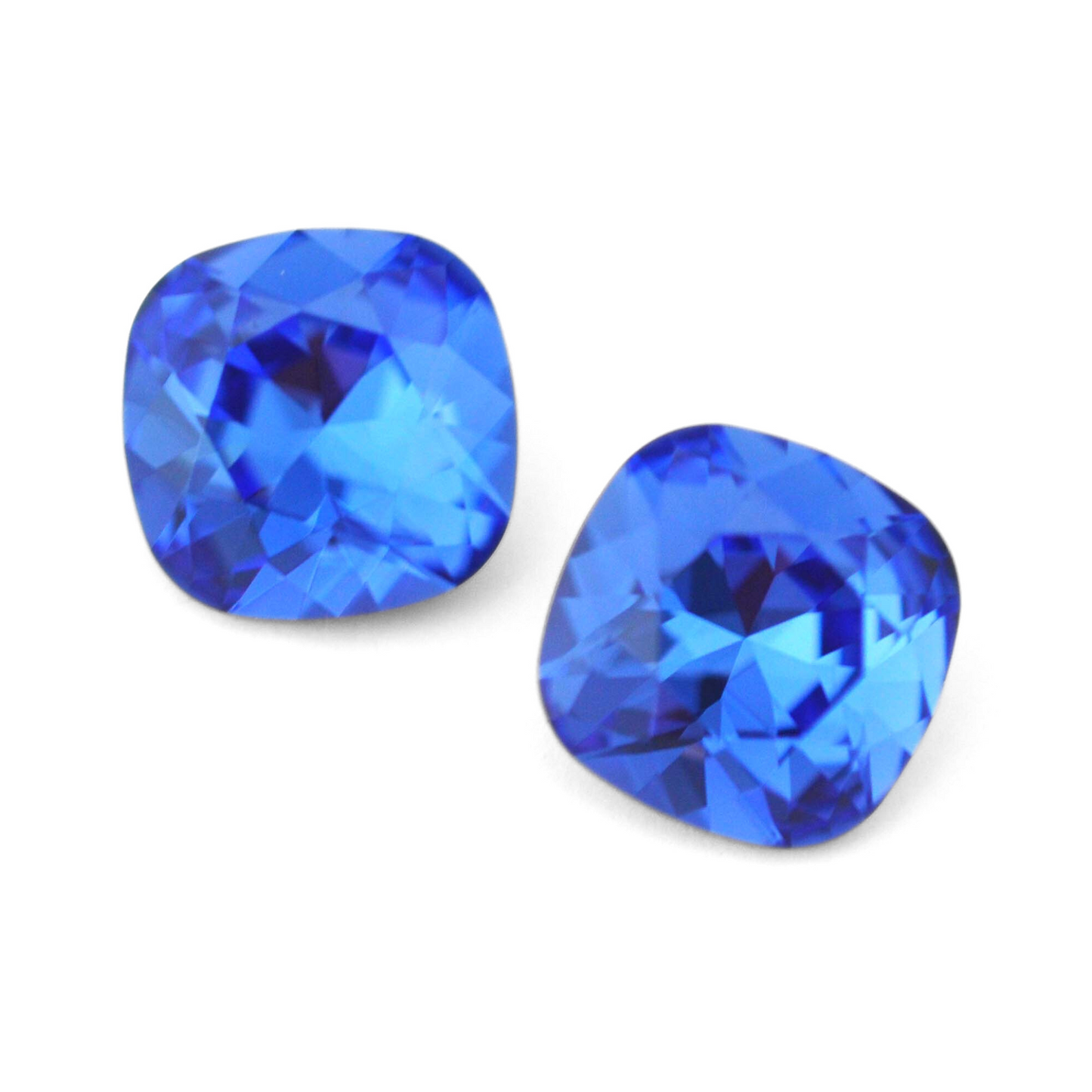Cushion Square faceted Austrian crystal rhinestones in the color Sapphire displayed on a white background.