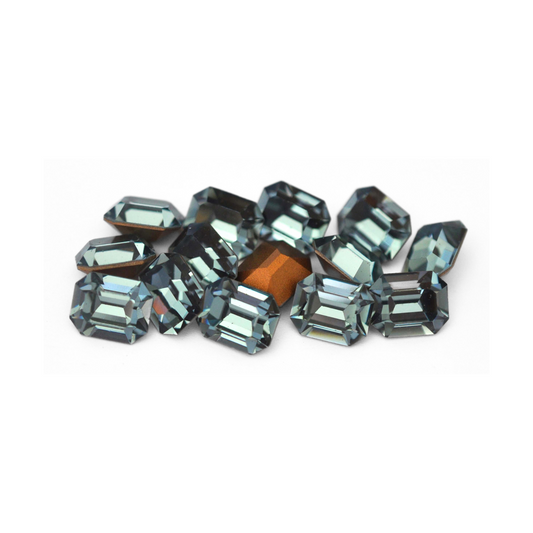 Octagon shaped faceted Austrian crystal rhinestones in the color Indian Sapphire displayed on a white background.