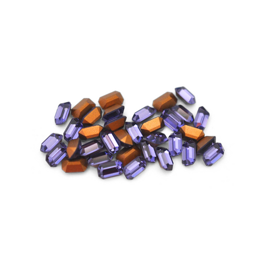 Octagon shaped faceted Austrian crystal rhinestones in the color Tanzanite displayed on a white background.