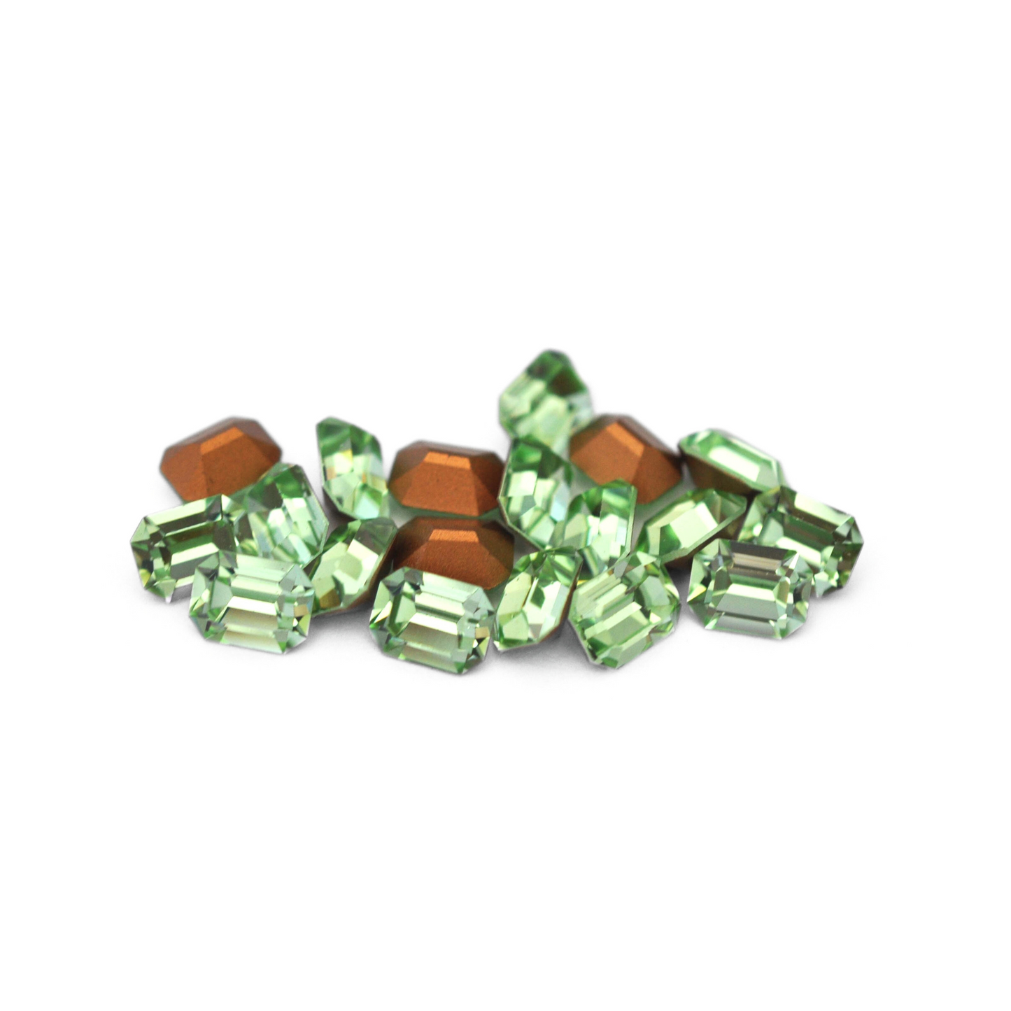 Octagon shaped faceted Austrian crystal rhinestones in the color Chrysolite displayed on a white background.