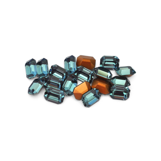 Octagon shaped faceted Austrian crystal rhinestones in the color Indian Sapphire displayed on a white background.