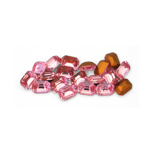 Octagon shaped faceted Austrian crystal rhinestones in the color Light Rose displayed on a white background.