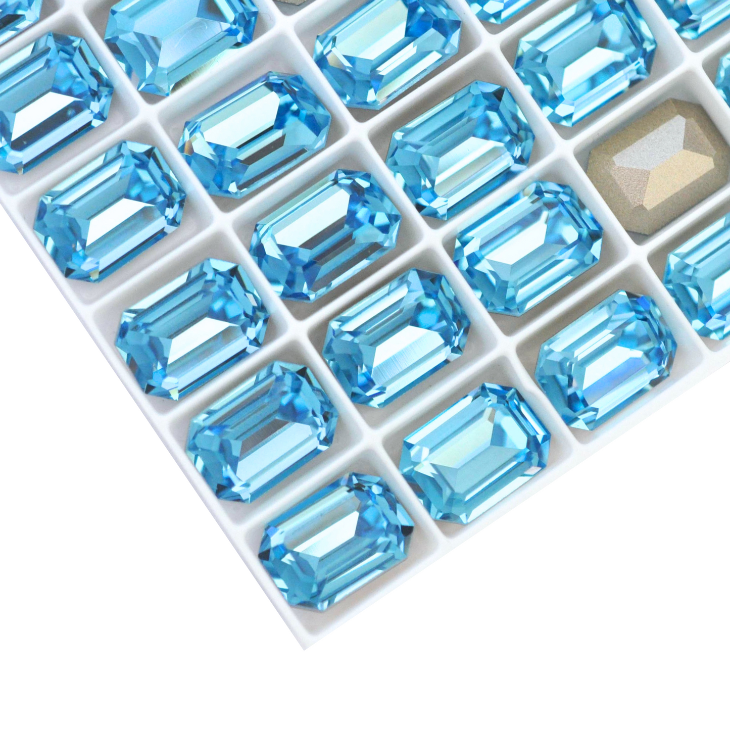 Octagon shaped faceted Austrian crystal rhinestones in the color Aquamarine displayed on a white background.